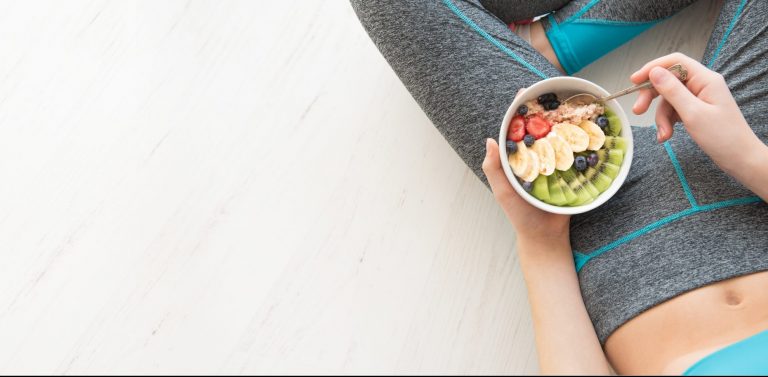 Young Woman Is Resting And Eating A Healthy Oatmeal After A Work